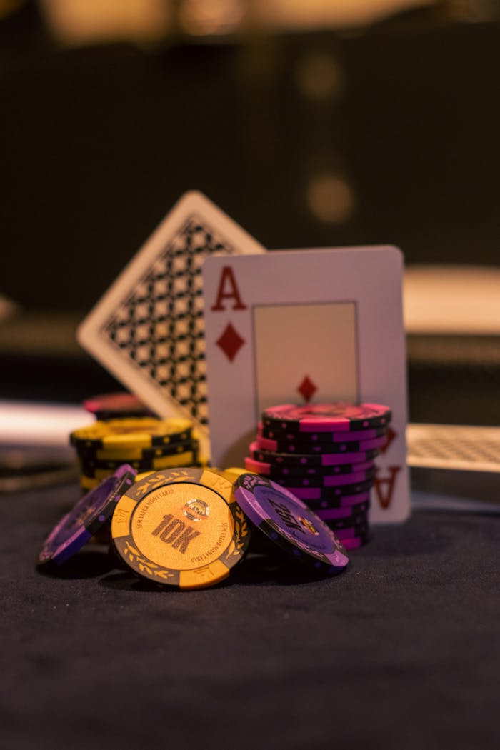Close-up of poker chips and playing cards on a casino table, great for gambling themes.